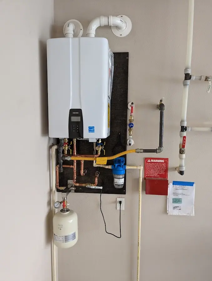 Professional plumber installing copper piping in a Whitehouse home